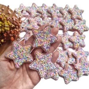 ESTRELA EM LONITA COM GRANULADO E STRASS 50MM COLORIDO CLARO UND
