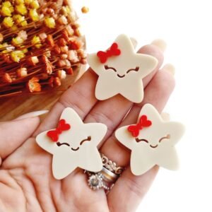 ESTRELA ANIMADA 3,5CM COM LAÇO VERMELHO UND