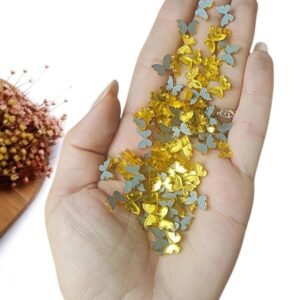 APLIQUE EM ACRÍLICO MINI SILUETE BORBOLETA 1 CM DOURADO C/ 10 UND