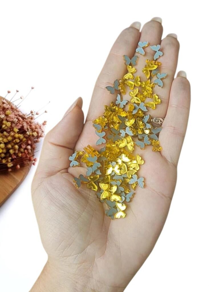 APLIQUE EM ACRÍLICO MINI SILUETE BORBOLETA 1 CM DOURADO C/ 10 UND